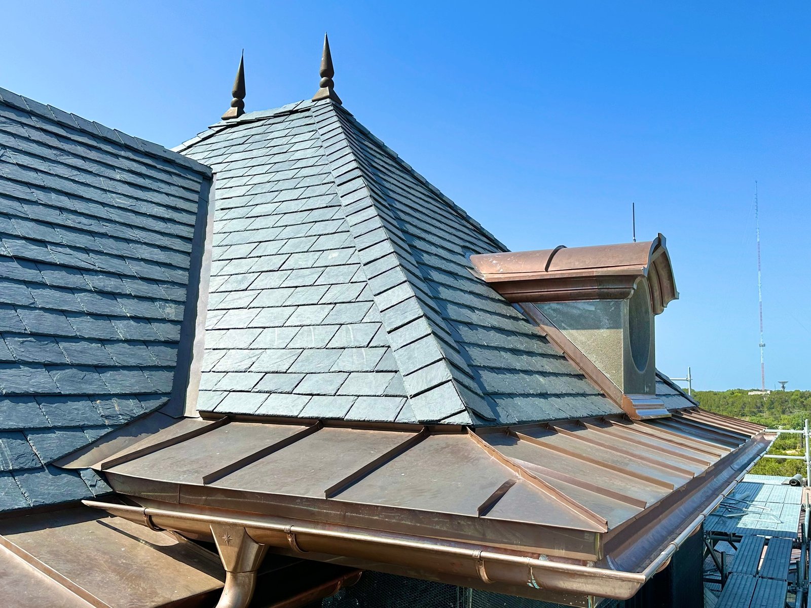 Heritage roof renewal with grey-green slate tiles